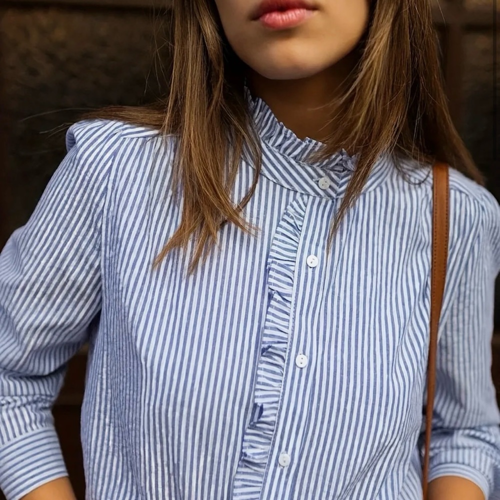Style and class in this preppy striped ruffle collar blouse!